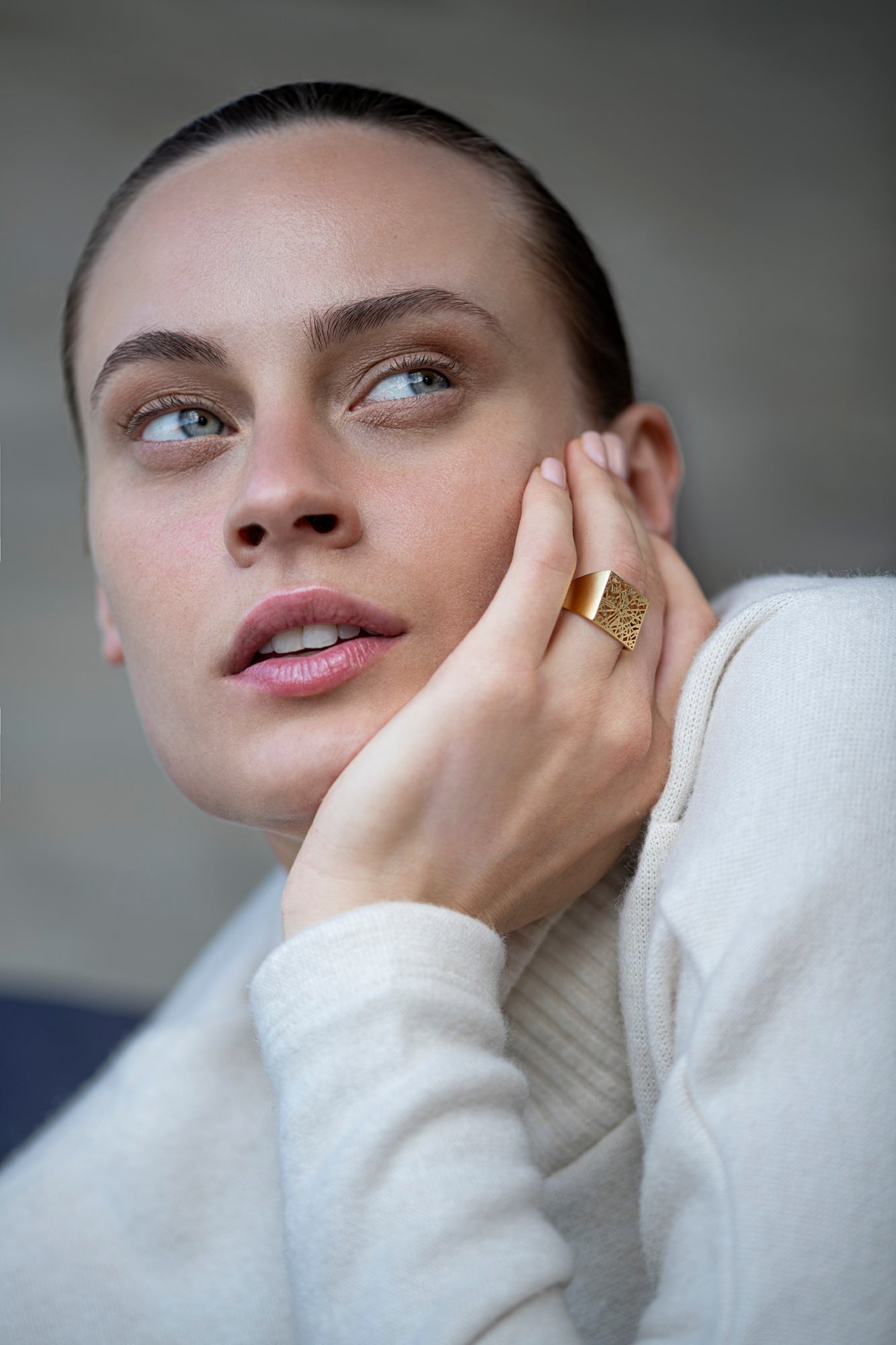 Close-up of a woman’s hand wearing a Talia Sari custom map square ring, designed from a real map to capture a personal story.